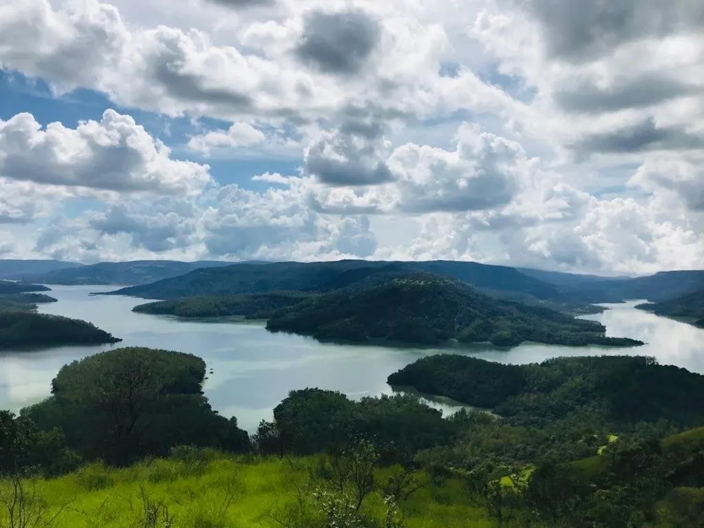 Shivsagar Lake winding between green hills at Tapola